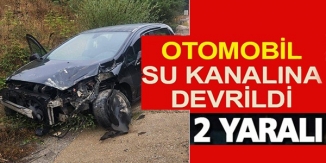 OTOMOBİL SU KANALINA DEVRİLDİ: 2 YARALI